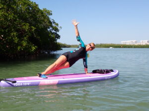 Jodi in yoga position on paddle board