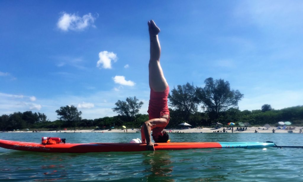 Jodi in handstand on paddle board
